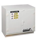 The Justrite Cabinet, Acid, Poly, U/C, Wht is designed for acid storage with durable Poly construction. It has warning labels in English, Spanish, and French with a safety symbol. The design includes two doors and a simple handle for optimal protection.