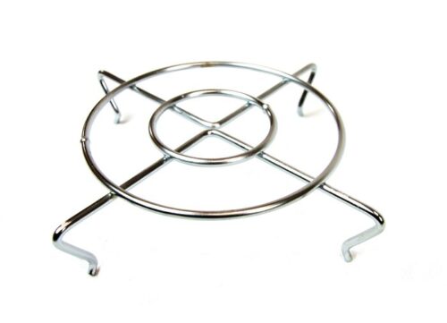 This metal trivet, similar to the Justrite Grill Guard, F/Cf Head 26265L, boasts a circular design with four sturdy legs and intersecting lines connecting its inner and outer circles for dependable support of hot cookware.