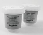 Displayed on a white background, the Aerslv coalescing filters come in a 2Pk set from Justrite Filter. Labeled Noclr Crtrdg, these gray cartridges have white tops with detailed printed information and logos prominently visible on the front.