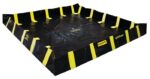 The Justrite Berm, Indust Qb 10X10X12, is a black spill containment berm with yellow straps and black-and-yellow striped edges, ideal for safely containing hazardous materials.