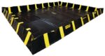 The Justrite Berm, Indust Qb 12X16X12, with its black design, yellow stripes, and labeled edges, is a sturdy rectangular structure. Its high sides make it ideal for spill containment or storage, ensuring a reliable choice against any backdrop.