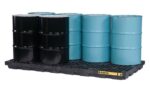 Six industrial barrels, three black and three blue, are neatly arranged in two rows on a black Justrite Accum Ctr, 8 Drum Ecopoly Blk spill containment pallet featuring a yellow label on the front.