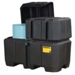 The Justrite Collection Ctr Dbl Drm, Eco Bk, features a hinged lid and displays a blue drum inside. A small yellow label with branding and safety symbols appears on the front. Designed for secure hazardous material storage, it showcases eco-friendly reliability.