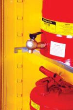 Inside a yellow Justrite Metal Storage Cabinet are two red safety cans; the top can is labeled caution with a valve spout, and the bottom has a closed handle. This cabinet, named Justrite Shelf Splslp, Dispng 30/45G, efficiently organizes chemicals with adjustable shelves.