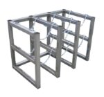Three Justrite Gcyl Barricade Racks, product code 3X2, Ss, are arranged in parallel. Each features a rectangular frame and chains for securing bicycles, offering sturdy support for cyclists to park and lock their bikes outdoors.