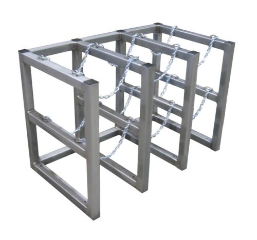 Three Justrite Gcyl Barricade Racks, product code 3X2, Ss, are arranged in parallel. Each features a rectangular frame and chains for securing bicycles, offering sturdy support for cyclists to park and lock their bikes outdoors.