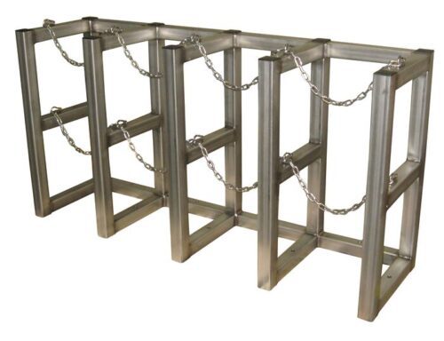 The Justrite Gcyl Barricade Rack,4X1,Ss features four rectangular frames with horizontal bars and chains for crowd control or security. Its metallic finish offers durability and distinctive style in managing public spaces.