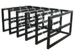The Justrite Gcyl Barricade Rack, 5X4, features a row of black metal frames linked by zigzag chains, creating an intriguing and strong structure.