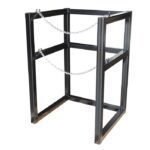 The Justrite Gcyl Barricade Rack, 1Cryo, 22In is ideal for industrial use with its black metal frame and two chains securing the robust vertical and horizontal bars to hold objects securely.