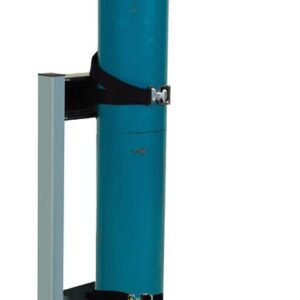A tall, cylindrical blue gas cylinder is secured upright with two black straps in a gray Justrite Gcyl Stnd, 1Cyl, Lckpst, Stl. The cylinder has a rounded top and some visible scuff marks showing wear.