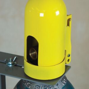 A close-up of a yellow Snapcap, partially revealing a coiled connection inside, secured to a metal bracket atop a gray gas cylinder. The focus is on the protective Justrite Gcyl Acc, Snapcap, Hpft and its attachment.
