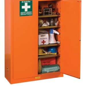 A Justrite Cabinet, Emergcy 65X43 Orng stands open, showcasing safety gear: first aid kit, emergency blanket, megaphone, radio, and hard hats. The door prominently displays a green sign with a white cross.