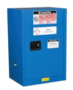 The Justrite Cabinet, Haz Mat Compac 12G Sc, is blue with warning signs saying Hazardous, Keep Fire Away and Acid Storage Cabinet. It includes a lock and safety symbols on the door.