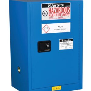 The Justrite Cabinet, Haz Mat Compac 12G Sc, is blue with warning signs saying Hazardous, Keep Fire Away and Acid Storage Cabinet. It includes a lock and safety symbols on the door.