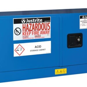 The blue Justrite Cabinet, Haz Mat Pigybk 12G Sc, is designed for acid storage and features warning labels like Hazardous Keep Fire Away. It includes two doors, a lockable handle, and hazard symbols against a white background.