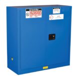 The blue Justrite Cabinet Haz Mat Chemcor 30G Sc includes warning labels—Hazardous Keep Fire Away on the left door and Acid Storage Cabinet on the right. It has a black handle and a small base warning symbol for enhanced safety.