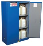 The Justrite Cabinet Haz Mat Chemcor 45G Sc, painted blue and labeled Hazardous: Keep Fire Away, stands open with shelves holding white plastic containers, ensuring safe chemical storage.