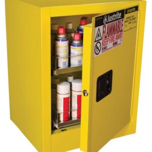A yellow Justrite Cabinet, Aero Bntp 4G, Man Yel is seen with the door slightly open showing shelves filled with bottles and containers. Warning labels for flammable materials and safety instructions adorn the cabinet, ensuring secure storage.