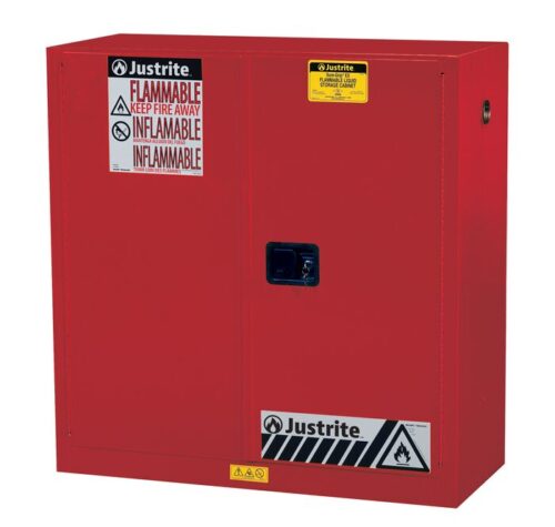The Justrite Cabinet, Flam Sfty 30G Man Red, has a yellow label and front handle, featuring Flammable and Inflammable warnings with hazard symbols for safe flammable material storage.