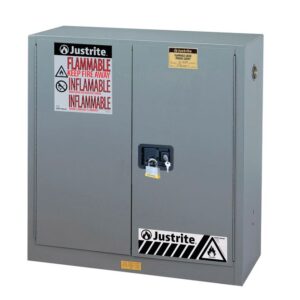 The Justrite Cabinet, Flam Sfty 30G Man Gry, is a gray metal safety cabinet with a sleek black handle and padlock. It’s labeled “Flammable” and “Inflammable” to warn against fire hazards, ensuring secure storage for hazardous materials.