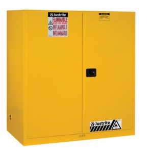 The Justrite Cabinet is a yellow flammable liquid storage unit with dual doors. It features multilingual Flammable labels and warning symbols on the front. It is compatible with Vdrum (2)55G Sc Yel containers for enhanced safety.