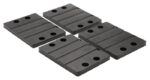 Four rectangular black Justrite Chock,Ac,Acc,6856,Rpad rubber mats with grooves and a grid of four holes are displayed on a light gray background, offering functionality and sleek aesthetics.