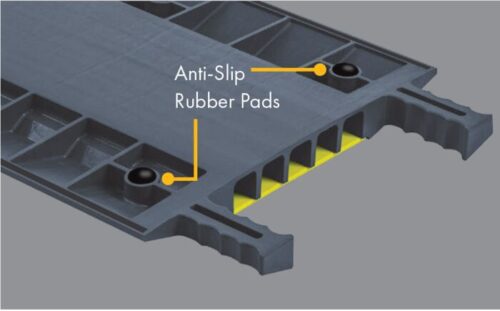 Close-up of Justrite Cp,Acc,Rpad Kit,1,8Pk gray modular panel features anti-slip rubber pads and yellow hollow compartments. Edges have serrated grips for safety.