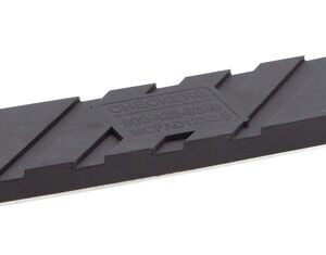 The Justrite Chock, Mc, Acc, 3009 Rpad is a black rectangular rubber pad with two round holes on each side, featuring diagonal grooves and a raised center text for a sturdy and reliable design.