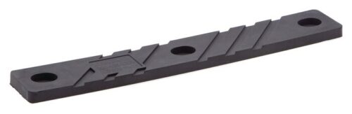 The Justrite Chock, model Acc 3010, is a black rectangular plastic strip featuring two large circular holes at each end and a smaller central pattern with diagonal lines and a hexagonal shape.
