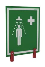 The Justrite H emergency safety shower sign, supported by two red clamps, displays a pictogram of a person under a showerhead with water droplets and a white medical cross.
