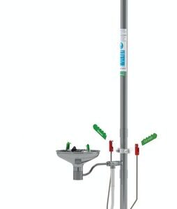 The Justrite H emergency safety shower and eyewash station includes a Combshwr head, an open stainless steel basin, dual green eye and shower signs, and green activation handles, all mounted on a sleek silver pole.