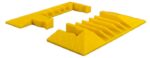 Two yellow wedge-shaped wheel chocks by Justrite with textured patterns for grip are showcased on a white background, one fully visible and the other partially, highlighting their reliable design. Product: Justrite Cp,Yj,5Ch,1.25,Eb,Y.