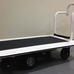 A white flatbed cart with black wheels and a curved handle features a black non-slip platform. With a 3000 lb. capacity, it stands on a gray speckled floor by a light wall, set to tackle tasks like the Electro Kinetic Technologies Pony Express Motorized Platform Truck.