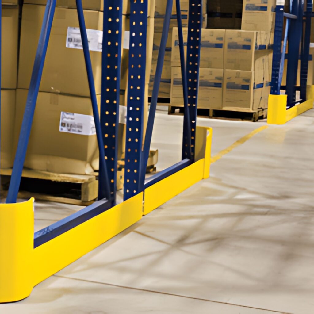 Warehouse shelves with Cogans metal blue frames and yellow guards brim with cardboard boxes. The concrete floor is spotless, and stacks of boxes are neatly arranged in the background.