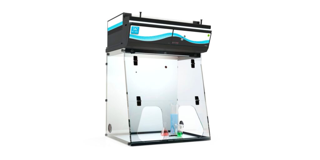 A laboratory fume hood equipped with advanced fume hood technology features a clear protective screen on three sides. Inside, two colored flasks, one red and one green, are visible. The unit boasts a black top with blue and white stripes and a digital control panel for precision.