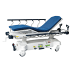 This hospital stretcher, essential in healthcare settings, features a cushioned blue mattress, an adjustable backrest, and collapsible side rails. Equipped with white wheels and control panels on the base, it ensures patient comfort and easy maneuvering.