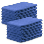 Two stacks of folded blue towels, reminiscent of those found in healthcare settings, are placed side by side. Each stack contains several neatly arranged towels, all identical in color and shape.