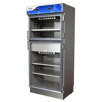 Large industrial stainless steel warming cabinet with two sections, ideal for healthcare settings. The upper section features a digital control panel with buttons and knobs. Inside, several metal racks suggest ample storage space. The doors are open for easy access to medical supplies.