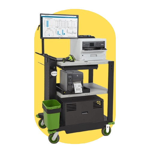 A NewCastle Systems mobile powered workstation features a mounted monitor displaying charts, a printer, and various electronic devices on shelves. A small green trash bin is attached to the side of this efficient setup, beautifully set against a yellow background.