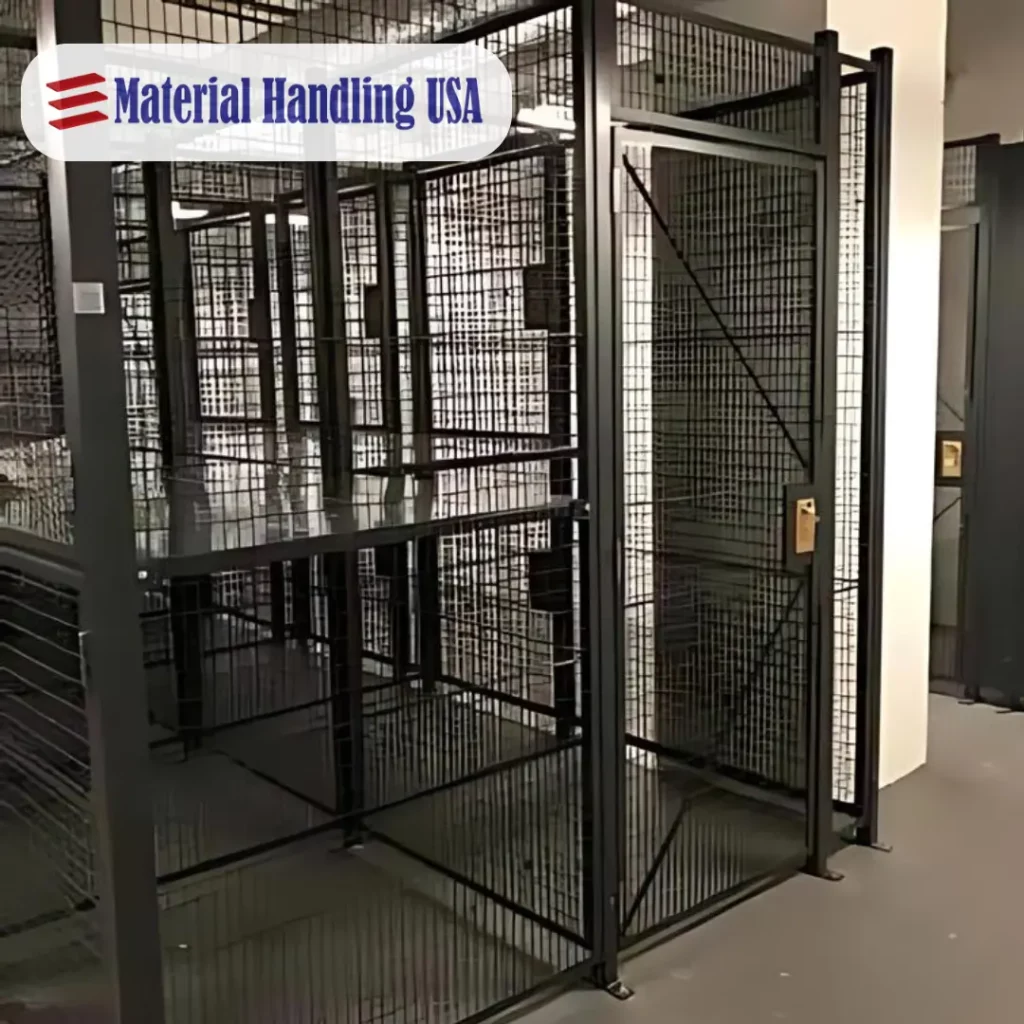 A black metal storage cage with a door stands in a room with white walls. The cage is designed for secure storage. The Material Handling USA logo is in the top left corner.