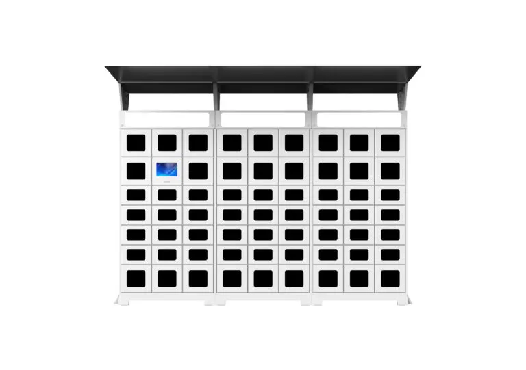 A large grid of black square slots on a white structure, akin to Utah parcel lockers, resembles a charging station or locker system. The top tier features a larger canopy. A single slot emits a blue light, possibly indicating activity or usage.