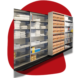 The office features mobile shelving for state offices, filled with neatly stacked white papers, folders, and documents. Vibrant binders and boxes add pops of color among the shelves. In the background, a white and red abstract shape enhances the modern workspace aesthetic.