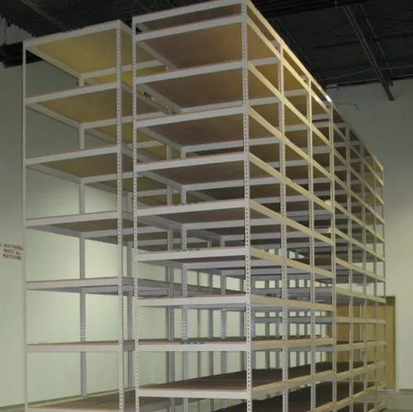 A large, empty industrial metal shelving unit stands with multiple levels in a spacious warehouse. The scene, bathed in light, highlights the blend of metal and wood on the shelves against high ceilings and pristine white walls.