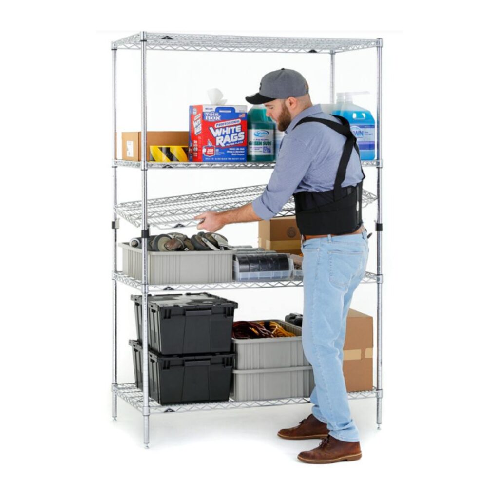 A bearded man in a cap and weighted vest organizes a Shelving EZ-ADD metal unit. The shelves hold cleaning supplies, boxes, tools, and containers. The plain white background highlights the efficient storage setup.