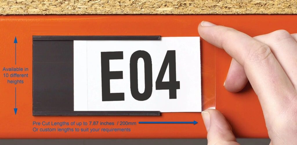 A hand is placing a white inventory identifier sticker with E04 on an orange rack. Text on the image reads Available in 10 different heights and Pre Cut Lengths of up to 7.87 inches / 200mm or custom lengths to suit your requirements. Perfect for managing low stock efficiently.