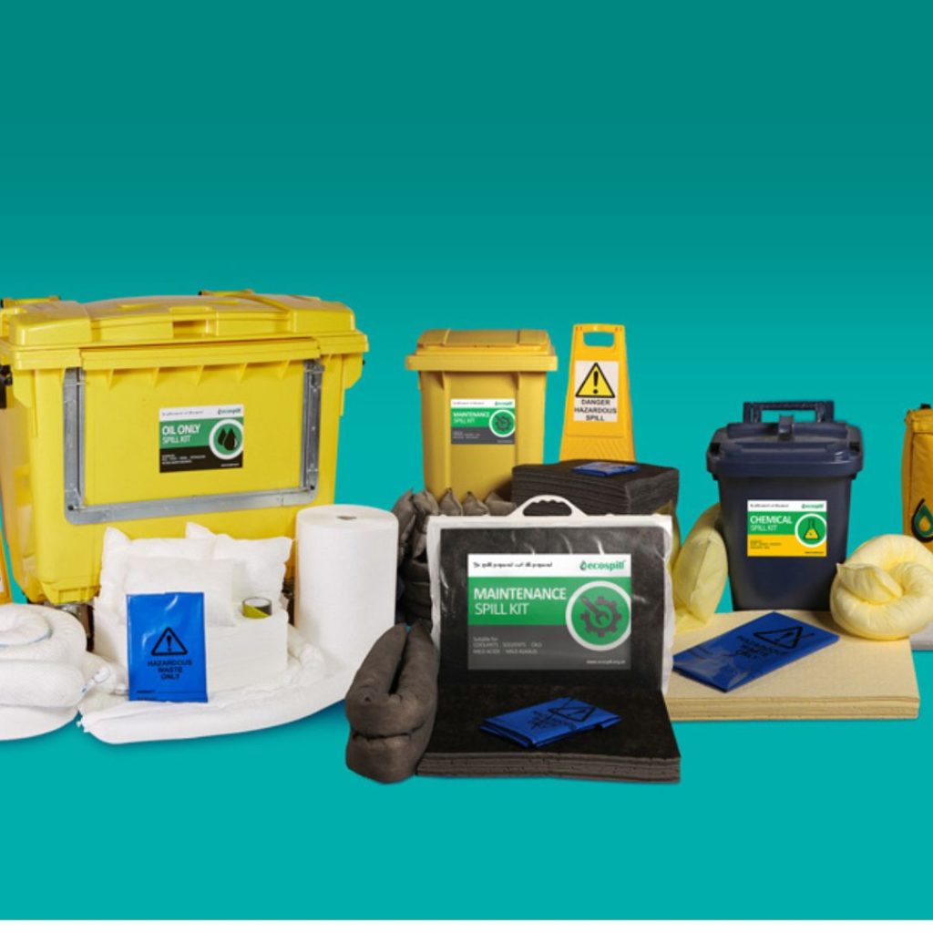 Spill kits and safety equipment are neatly arranged against a turquoise background, highlighting yellow containers, spill pads, absorbent socks, hazard signs, and disposal bags. This essential gear is designed for cleaning chemical and oil spills in educational facilities.