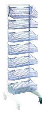The Quantum Partition Wall Add-On Unit is a tall, mobile, single-sided storage rack in a white and chrome finish, featuring seven blue wire baskets vertically arranged. It has four wheels (two with brakes), and each basket is slightly tilted for easy access to essentials.