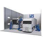 Two large white trucks are inside a modern gray-walled garage. Three workers in helmets use the BOOST™ Lift – Compressed Air-Powered Platform for Paint Booths & Hazardous Environments, labeled LPI, to reach the trucks upper sections.